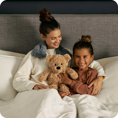 Image 103: Mother and daughter holding a Soft Lavender Scented Brown Curly Bear Warmies