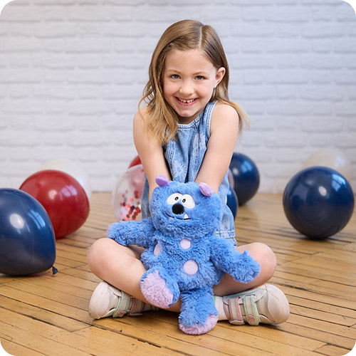 Image 102: girl holding blue monster stuffed animal