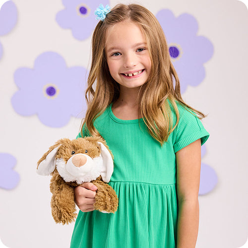 Image 103: girl holding brown bunny warmies flower lifestyle