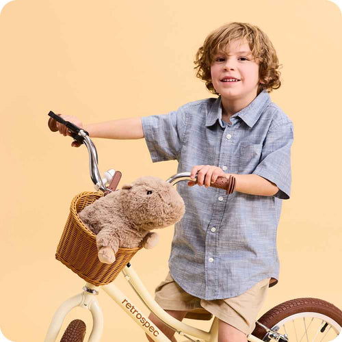 Image 102: Boy on bicycle with Cute Weighted Lavender Scented Capybara Stuffed Animal Heating Pad Warmies